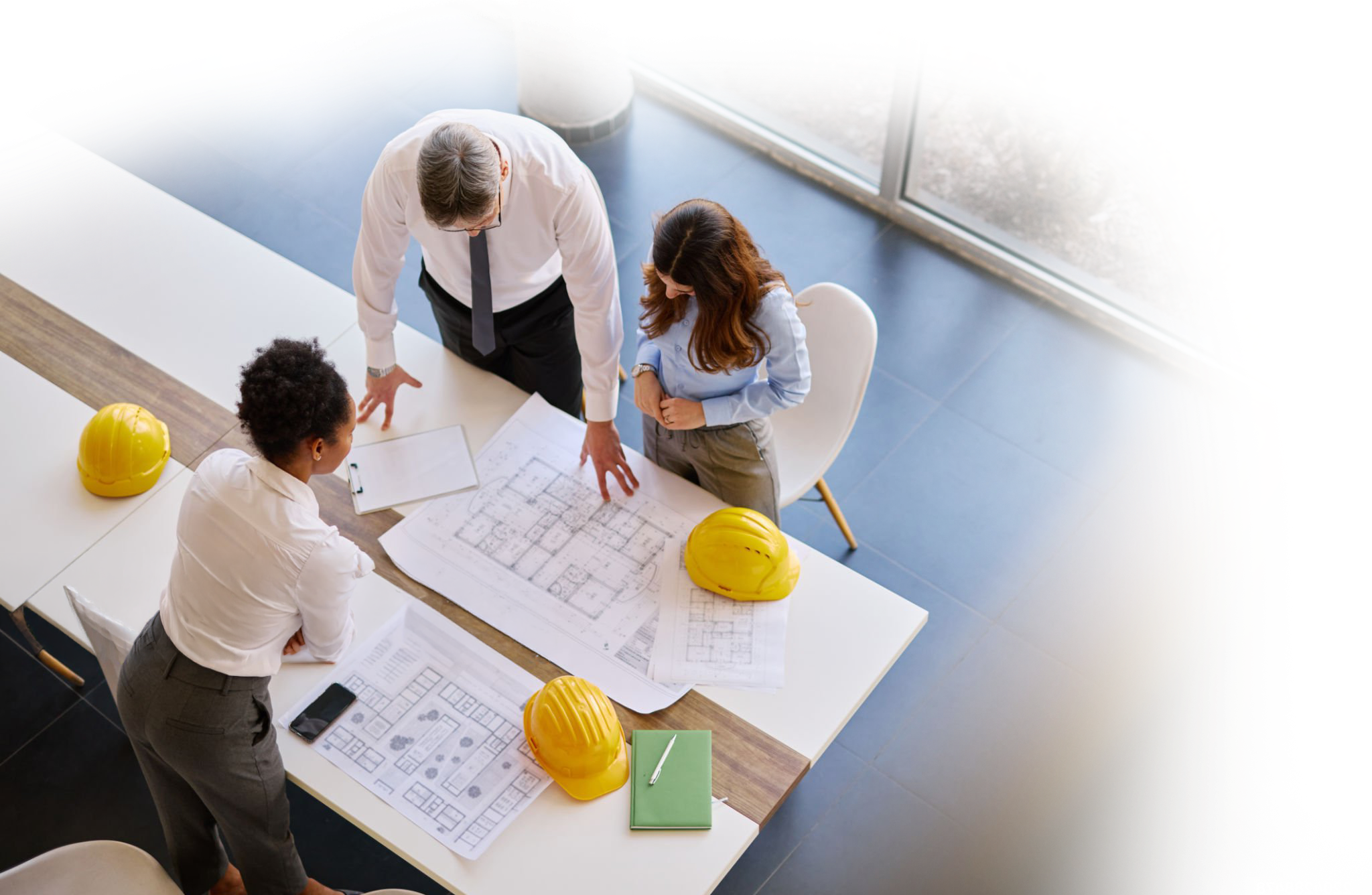 Engineers reviewing blueprints together